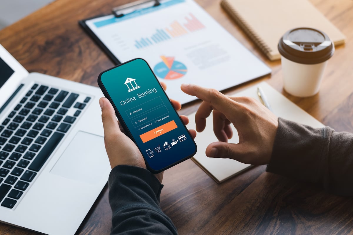 Man hand using online banking and icon on tablet screen device in coffee shop. Technology E-commerce Commercial. Online payment digital and shopping on network connection.